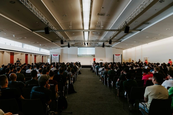 Photo of conference by Claudio Schwarz on Unsplash
